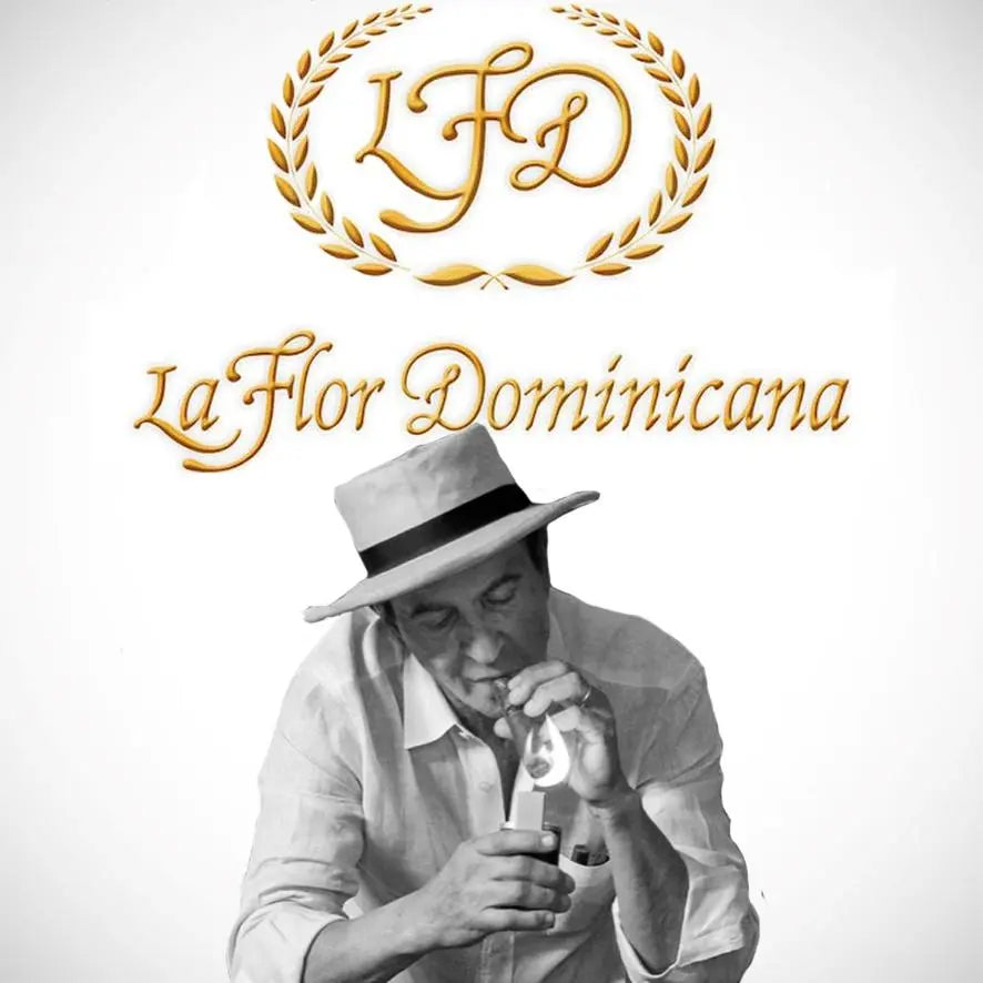 Litto Gomez, founder of La Flor Dominicana cigars, lighting a cigar with the LFD logo in the background