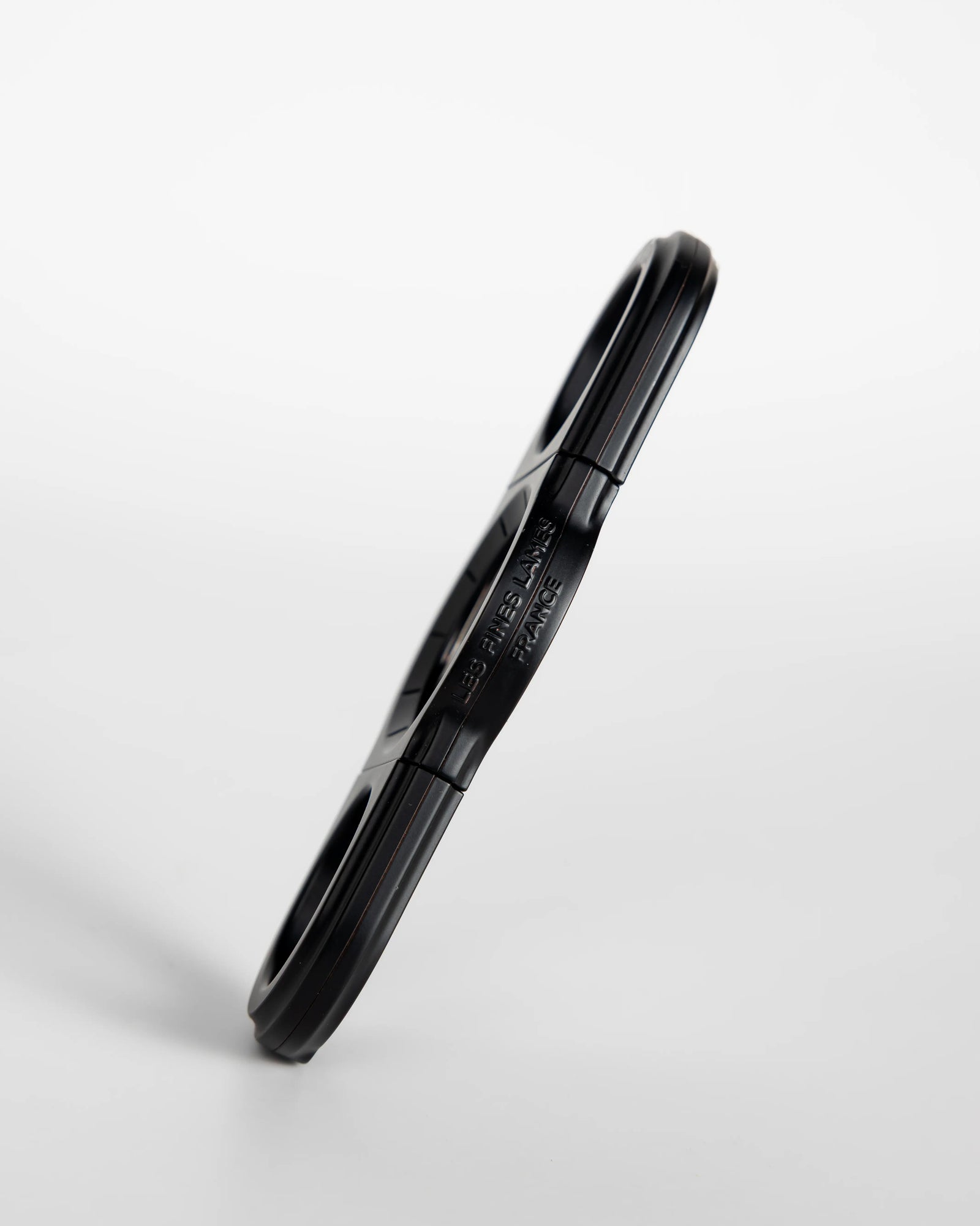 La Guillotine Rotor by LES FINES LAMES, a black stainless steel guillotine cigar cutter shown from the side