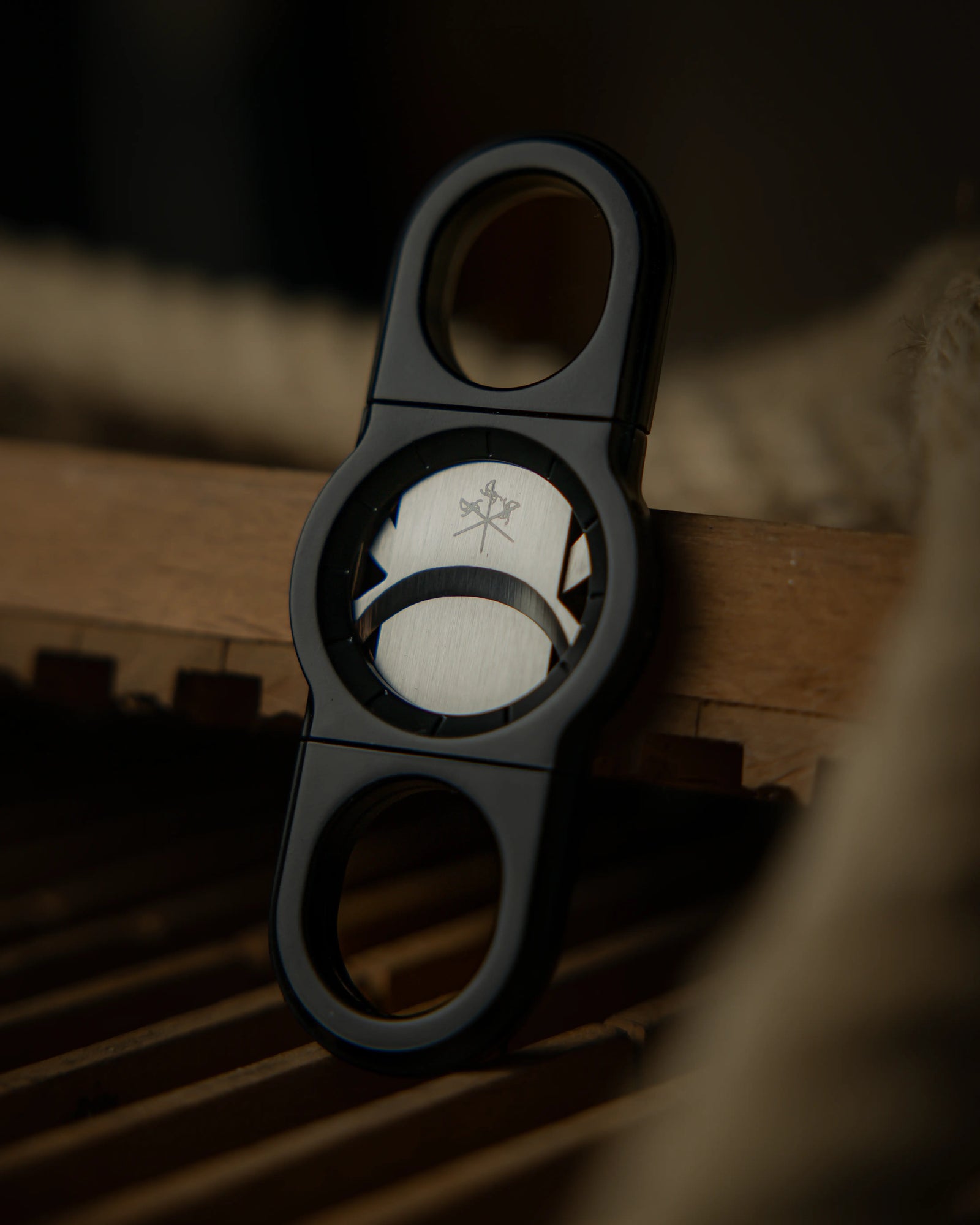 La Guillotine - ROTOR Black by LES FINES LAMES, black cigar cutter standing on a wooden surface