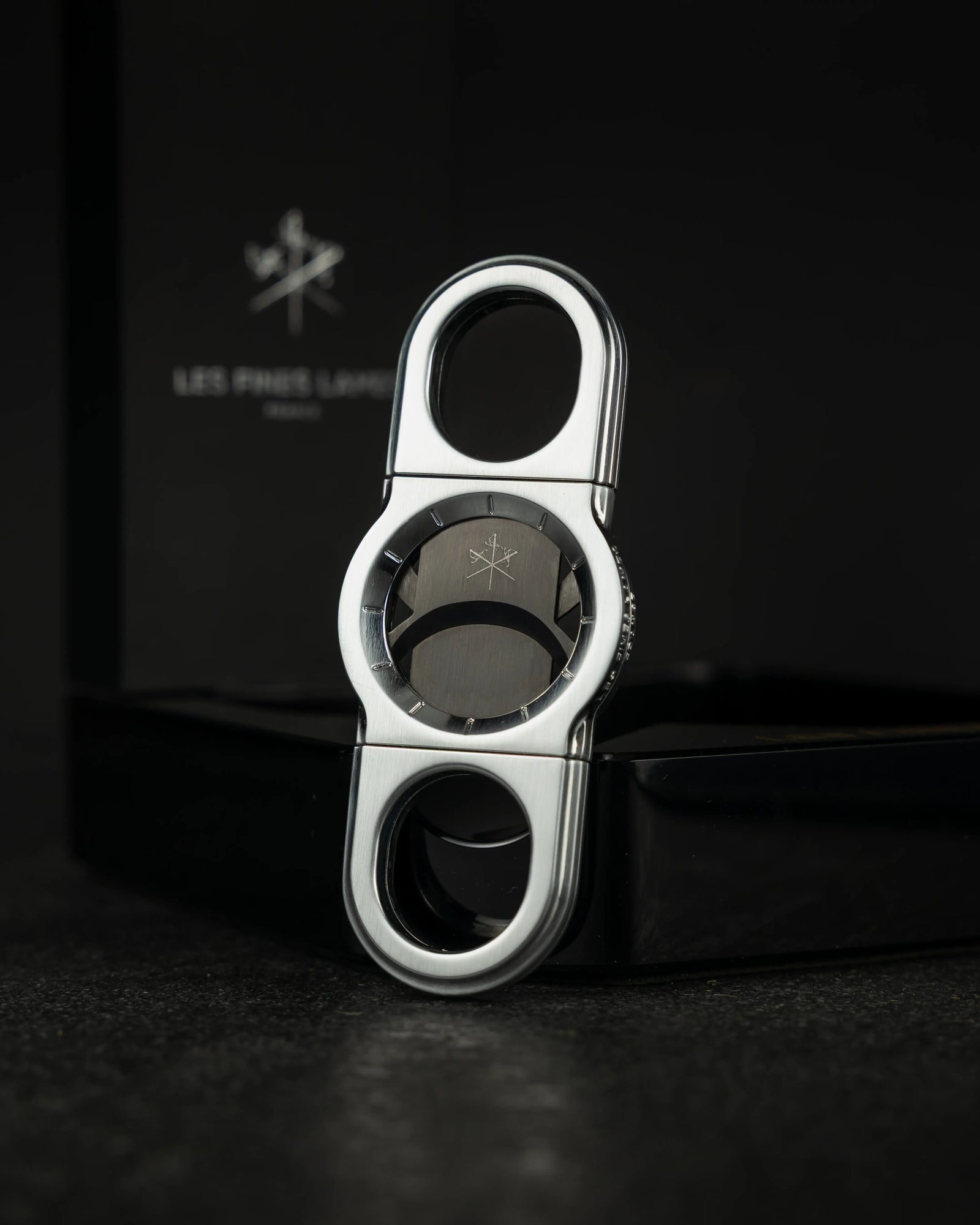 La Guillotine - ROTOR Chrome by LES FINES LAMES, chrome cigar cutter standing  in a dark setting