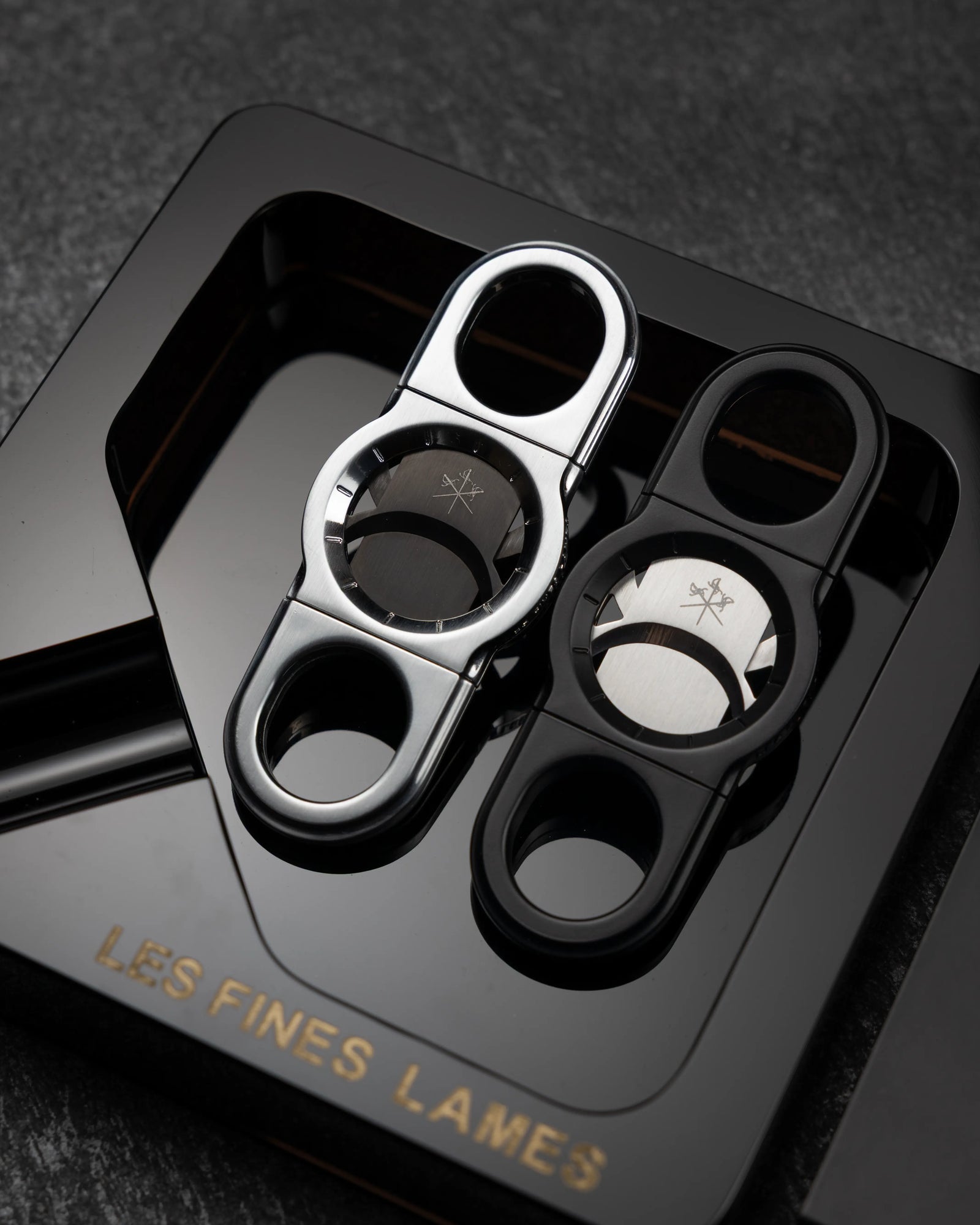 La Guillotine - ROTOR Black and Chrome by LES FINES LAMES, black and chrome cigar cutters displayed together