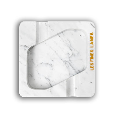 A square white marble-patterned cigarette case with a central cutout, featuring the text 'LES FINES LAMES' printed  on the right side, set against a plain white background.