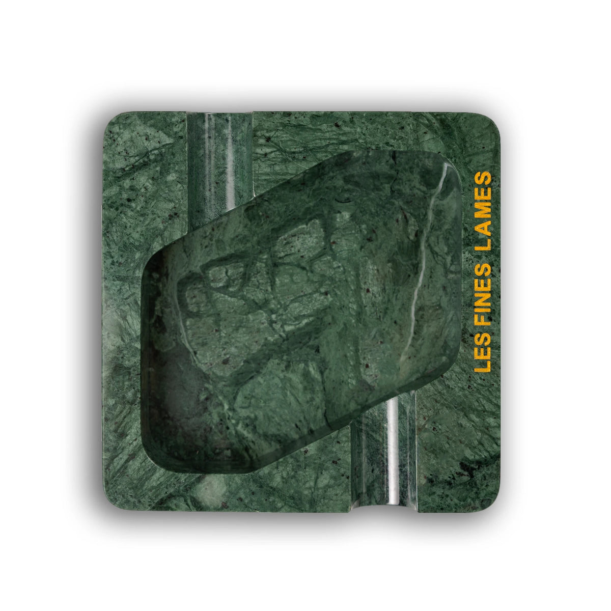 A square metal tin with rounded corners, featuring a dark green marble pattern with text reading 'LES FINES LAMES' on the right side, shown on a white background.