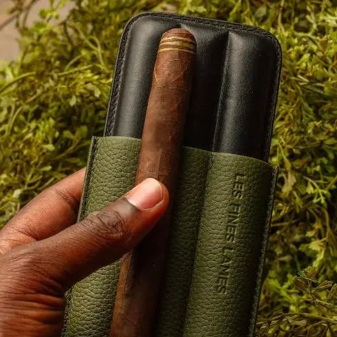 OD Green Cigar Case TRIO holding cigars outdoors in a travel setting