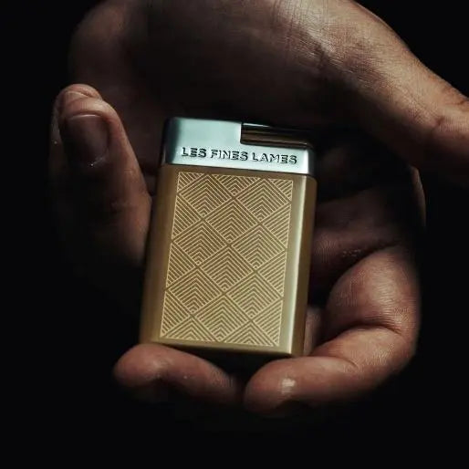 Le FEU SVELT FDE Leaves premium cigar lighter held in one hand